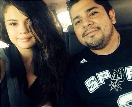 A picture of Ricardo Joel Gomez (wearing Spurs' jersey) with his daughter Selena Gomez.